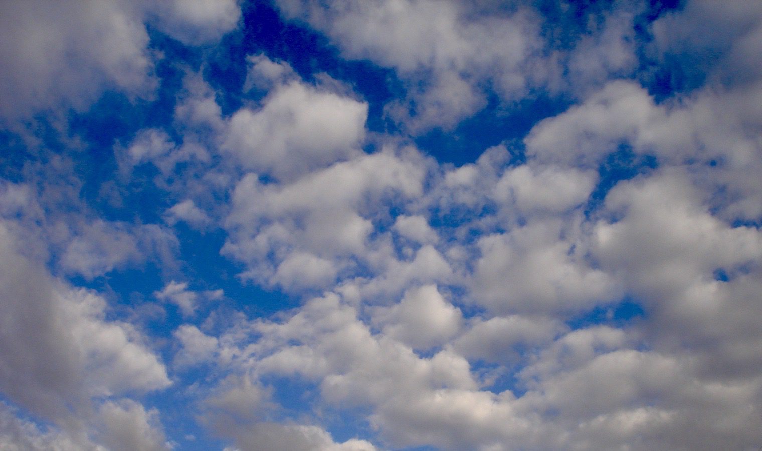 A blue sky with lots of clouds in it