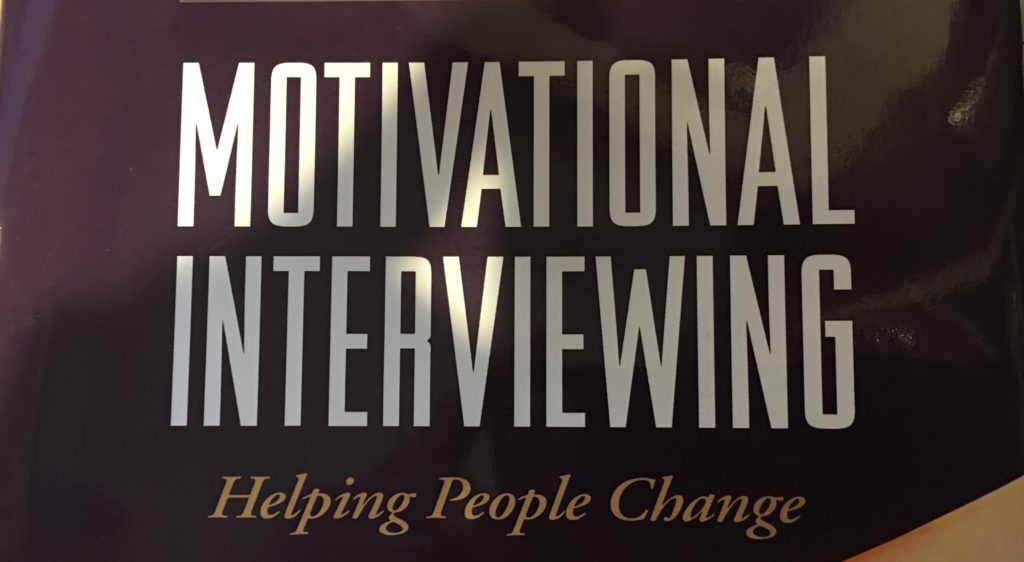 A sign that says motivational interviewing helping people change.