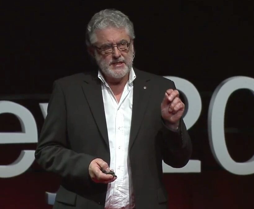 A man in a suit and tie standing on stage.