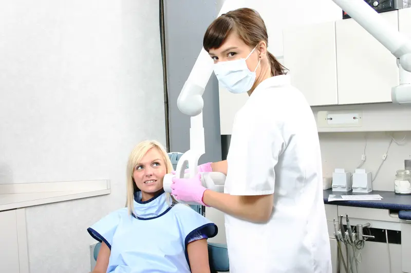 A woman sitting in front of another person.