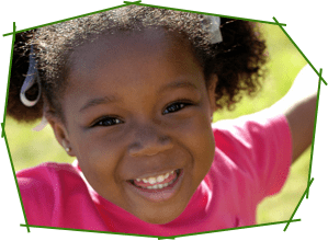 A close up of a child smiling for the camera